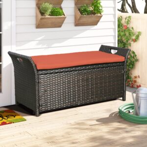 black wicker storage bench with an orange cushion