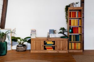 Modern living space featuring a wooden sideboard with colorful books