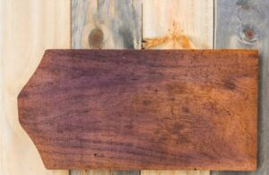 wooden signboard with a pointed end, featuring a rich brown color