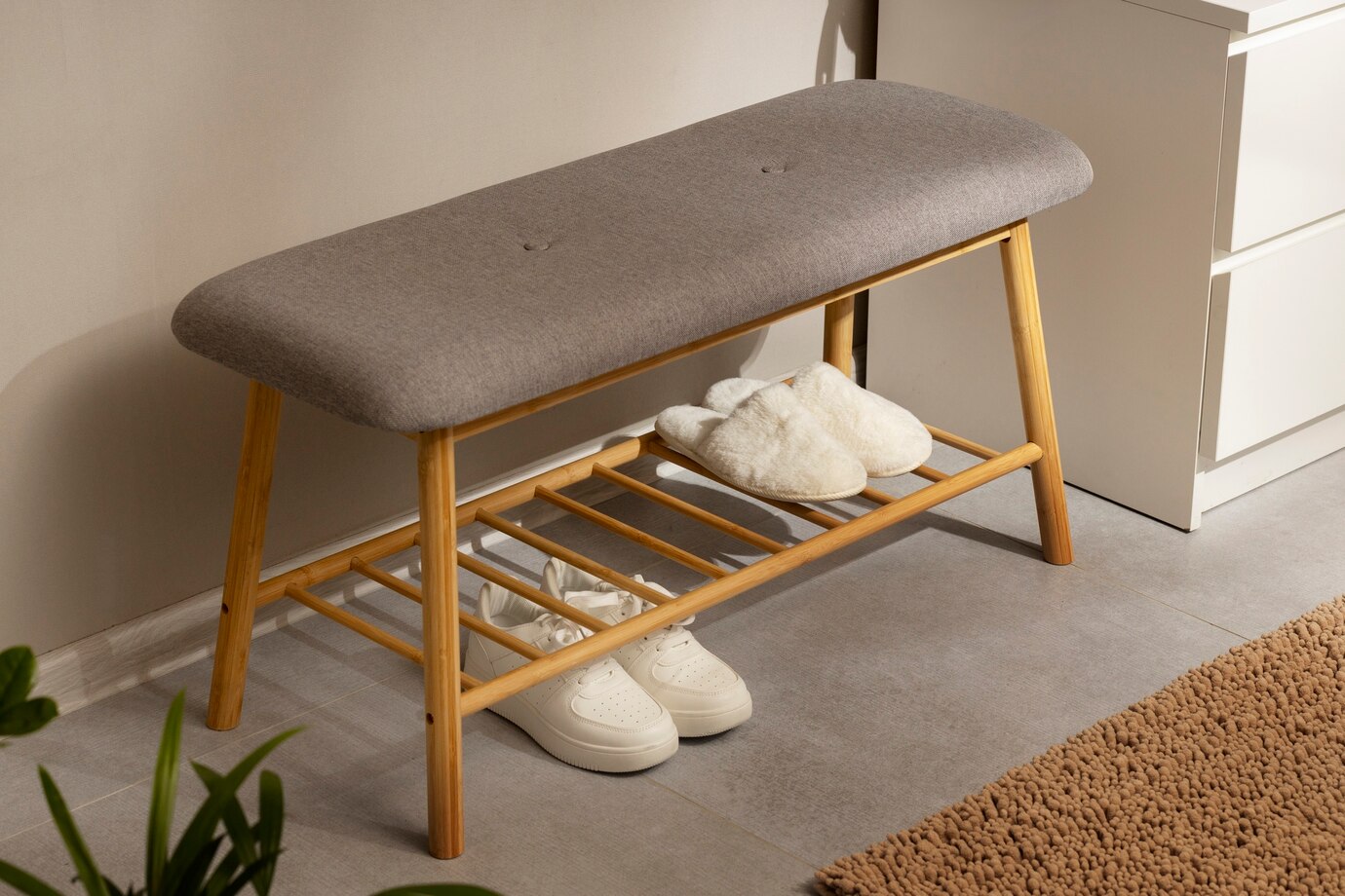 stylish gray cushioned bench with bamboo legs