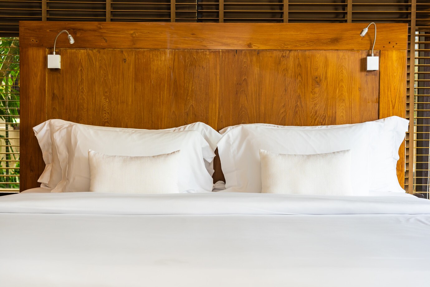 warm wood headboard, bathed in soft natural light