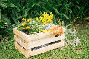 wooden planter filled with vibrant yellow and orange flowers