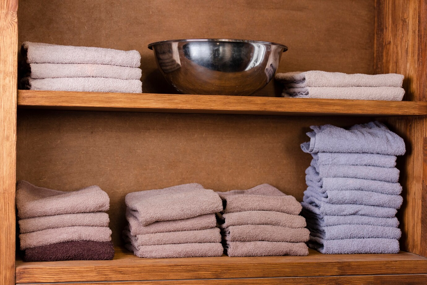 Neatly stacked towels in various shades of beige