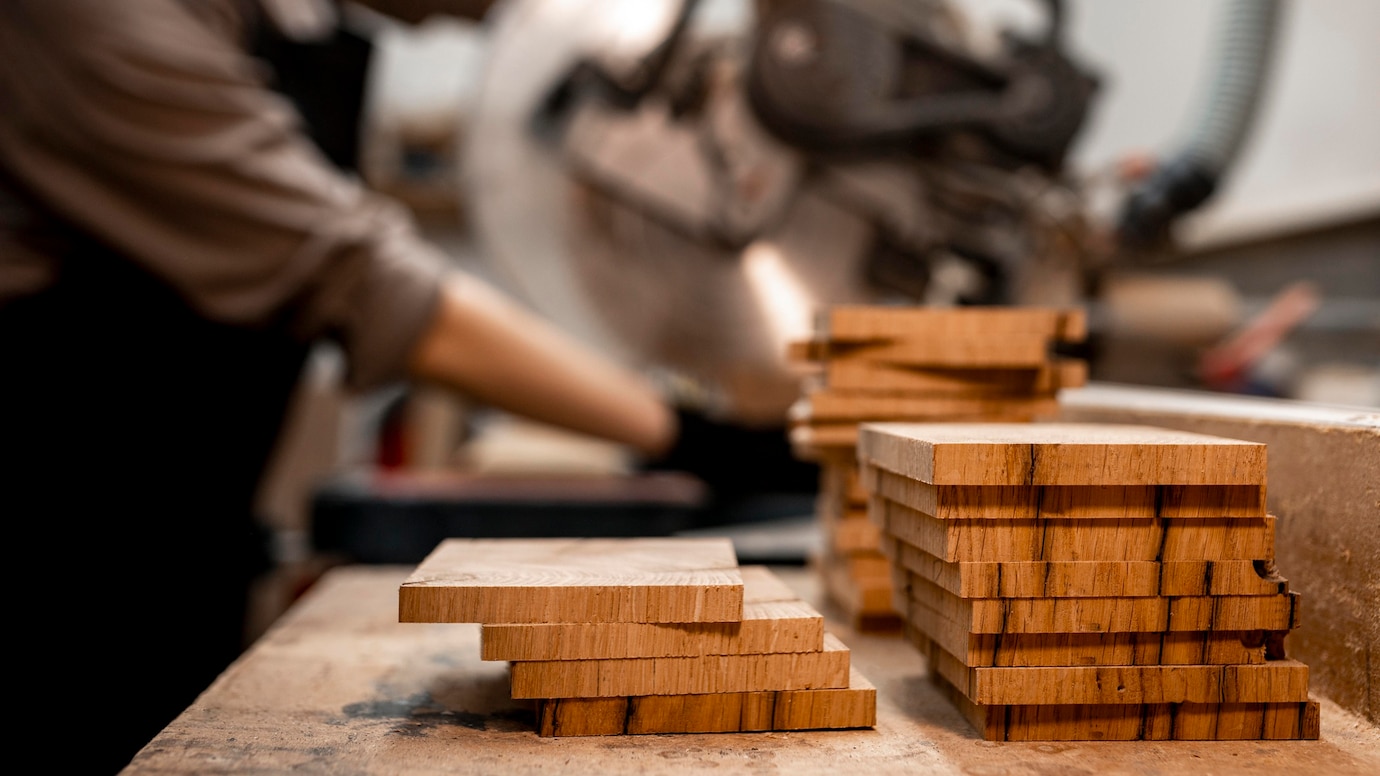 Close-up of neatly stacked wooden boards on a workbench