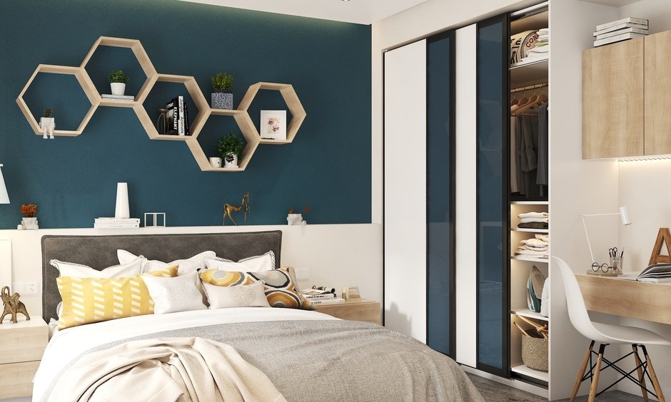 Cozy bedroom featuring a gray bed with colorful pillows, hexagonal shelves