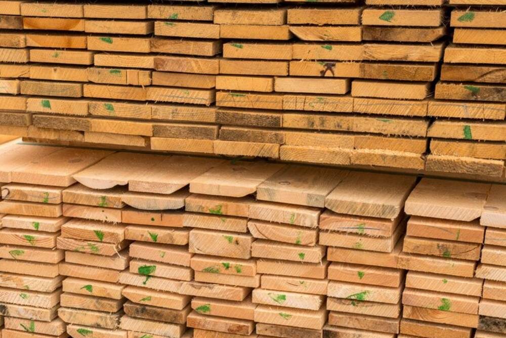 Stacked wooden planks of various sizes.