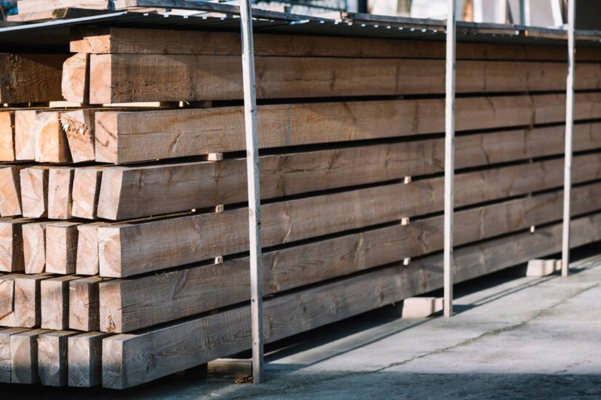 Stacked wooden beams store on a metal frame.