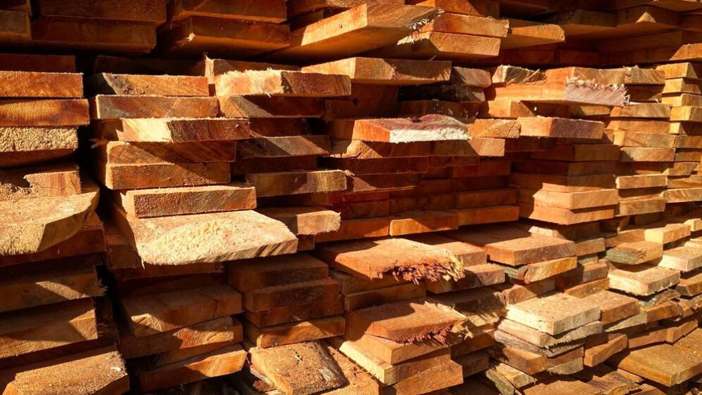 Stacked wooden planks in various sizes storage .